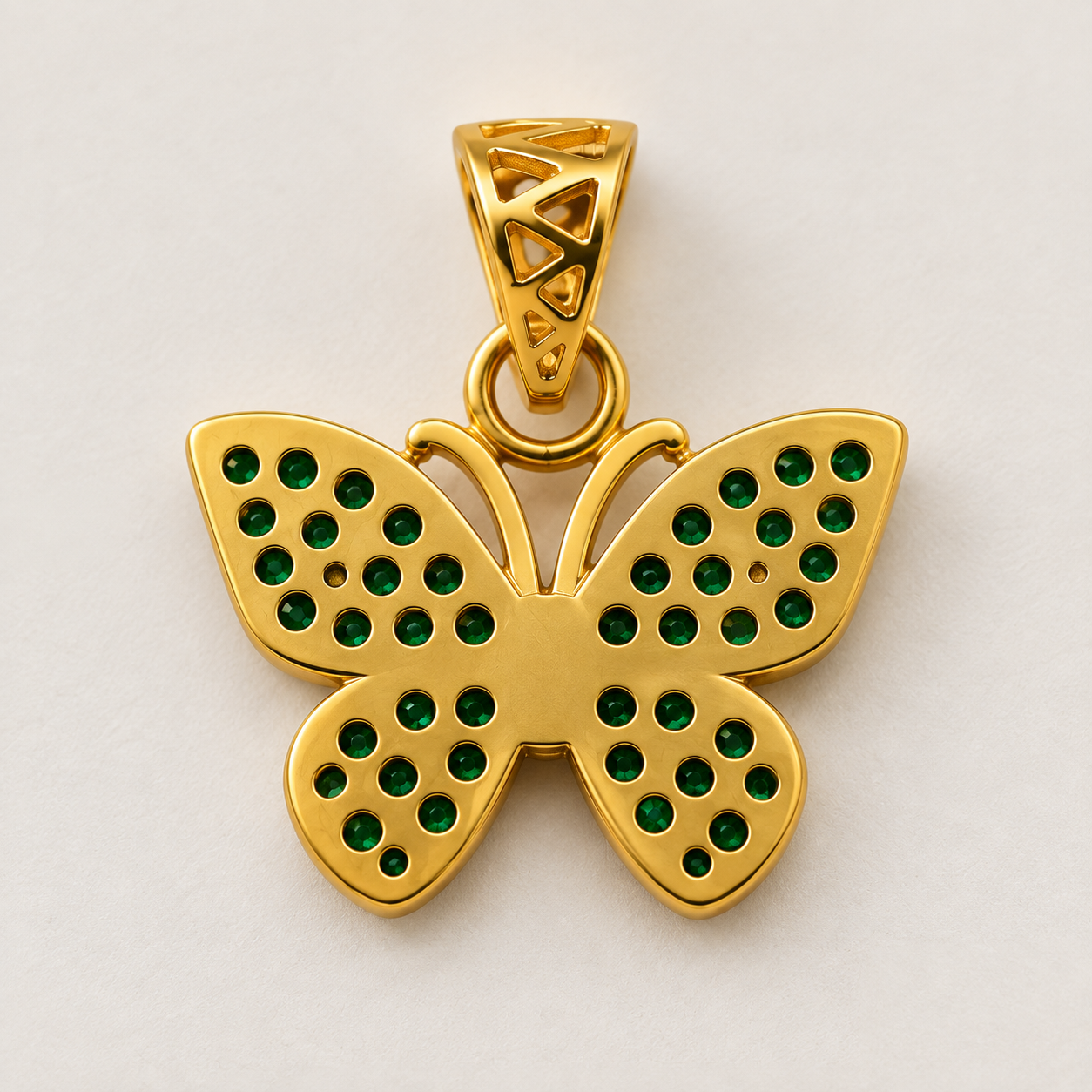 Back view of gold butterfly pendant showing stone openings and geometric openwork bail