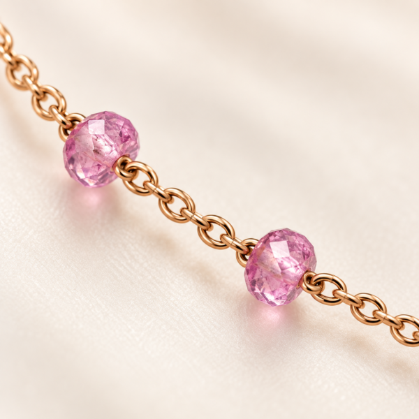 Close-up of faceted pink gemstone stations on delicate rose gold vermeil chain