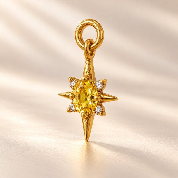 Solara Celestial Starburst gold-tone pendant with oval golden-yellow centre stone and clear accent stones