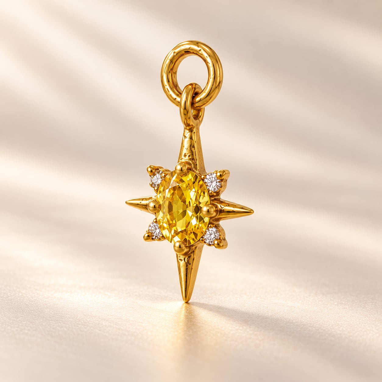 Solara Celestial Starburst gold-tone pendant with oval golden-yellow centre stone and clear accent stones