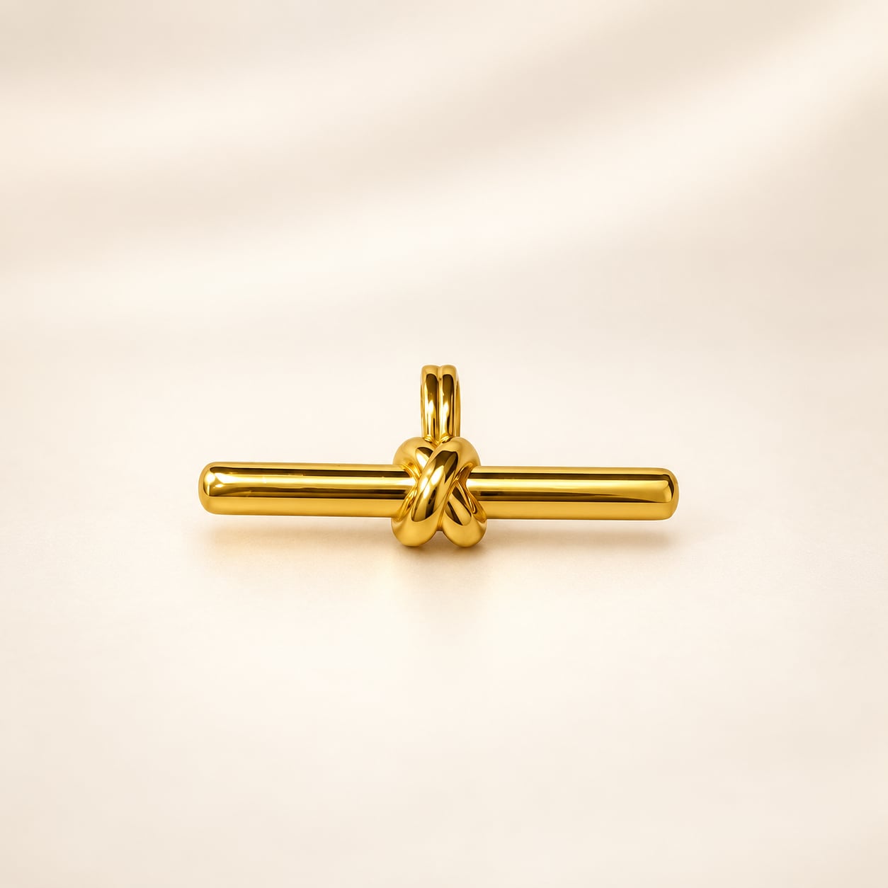 Aurelia Knot Bar Pendant in polished gold tone with sculptural centre knot, front view