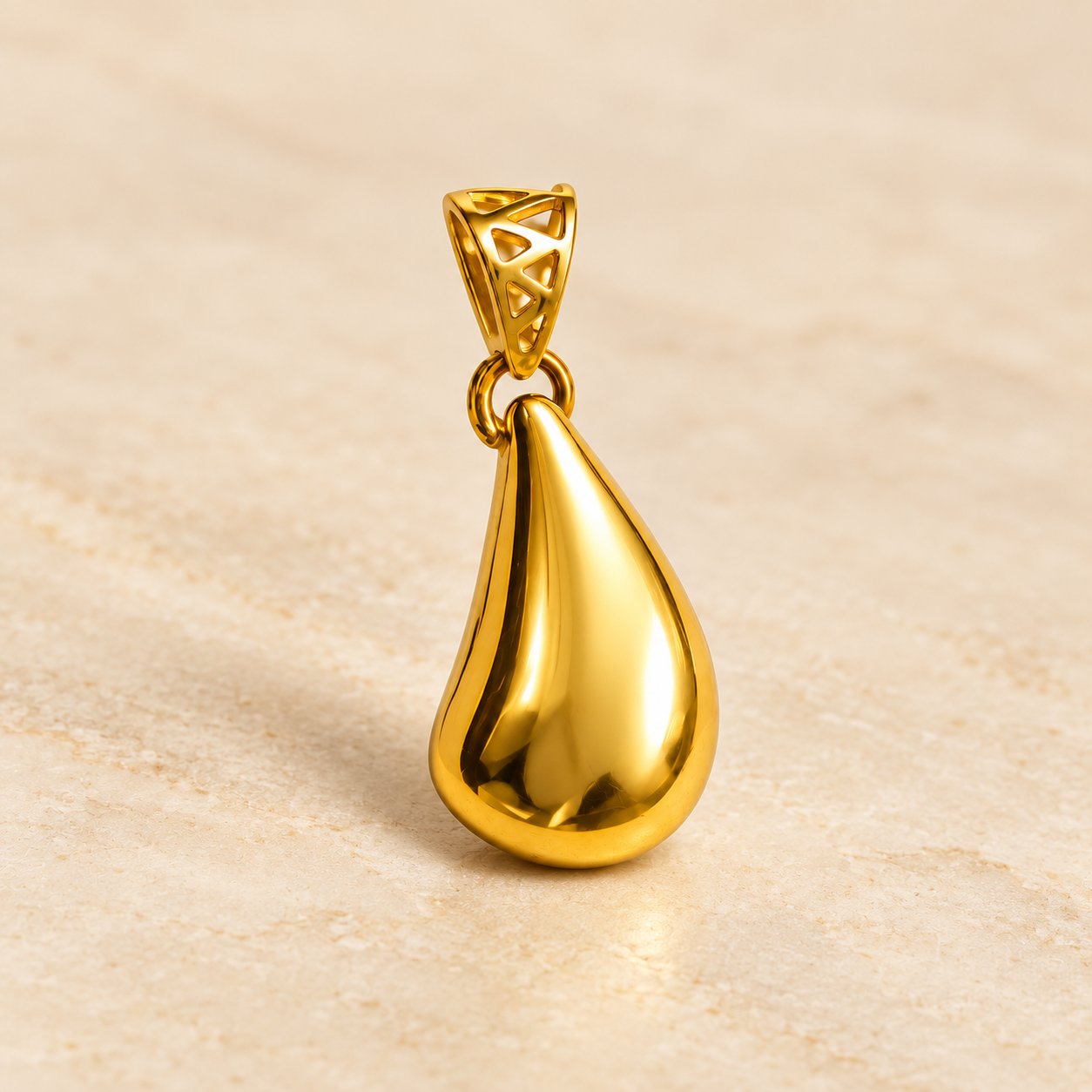 Three-quarter view of the Aurelia gold-plated sterling silver teardrop pendant showing its geometric openwork bail