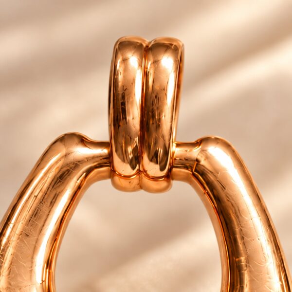 Close-up of the Seraphine Heritage Loop Pendant double bail and polished rose-gold surface