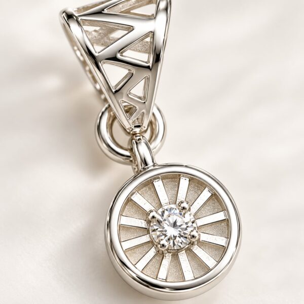 Close-up of Meridian Halo pendant showing clear centre stone, radial detailing and geometric silver-tone bail