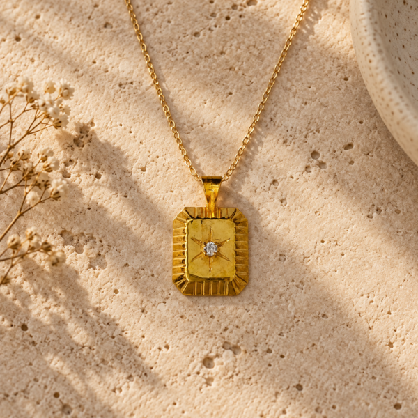 Polaris True North gold vermeil pendant necklace with North Star and white CZ styled on natural stone