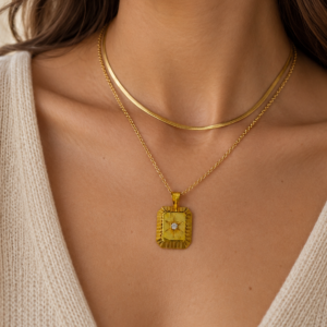 Polaris True North gold medallion layered with a herringbone necklace for a modern gold jewellery look
