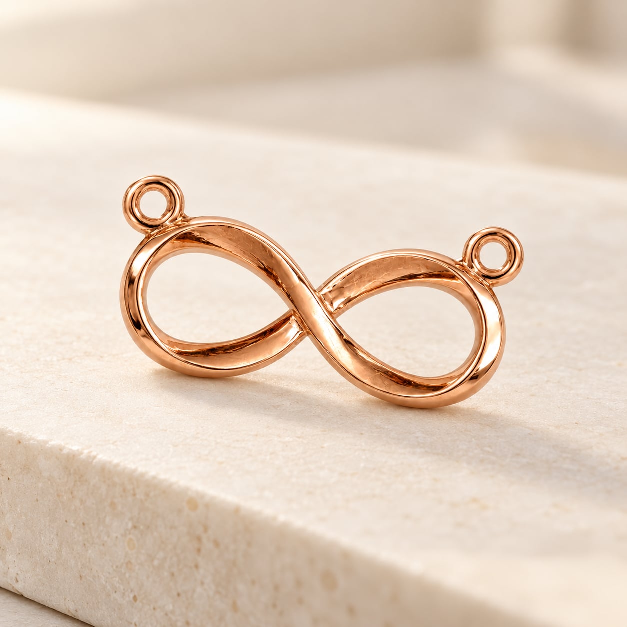 Eternal Flow 925 sterling silver infinity pendant with rose gold finish on ivory travertine